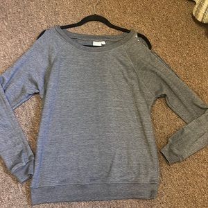Gray top with long sleeves and open shoulders.
